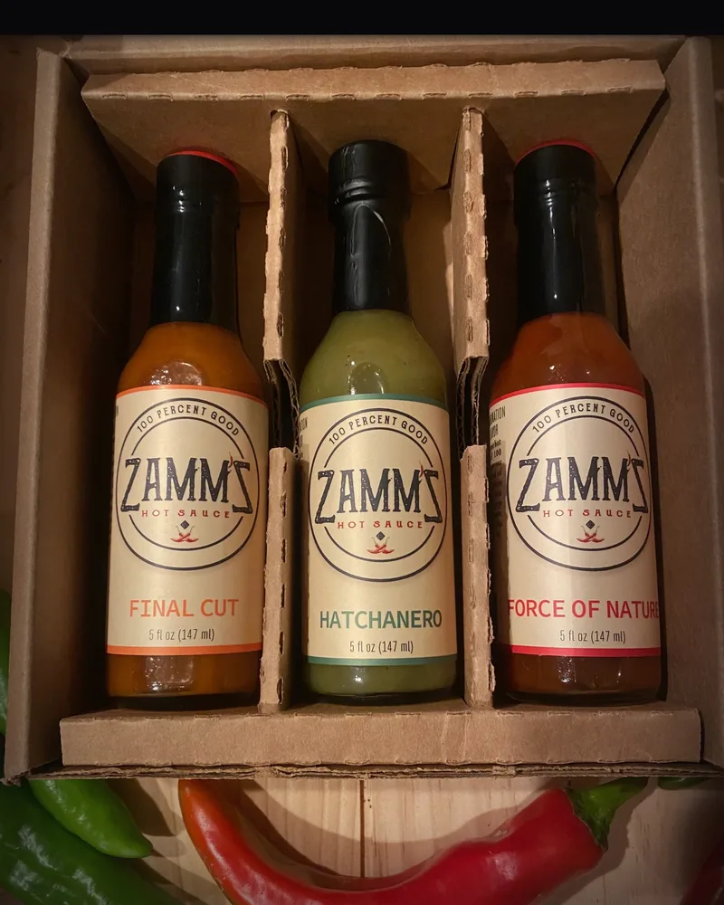 Three Zamm'Z hot sauce bottles in a wooden gift box