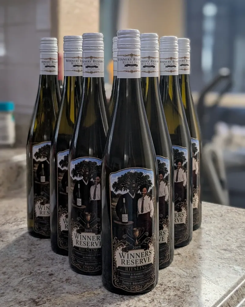 Winners' Reserve bottles with custom labels lined up on a kitchen counter