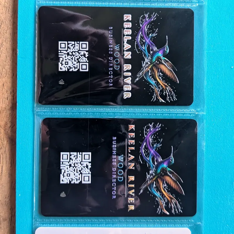 Printed Keelan River business cards with the hummingbird mark
