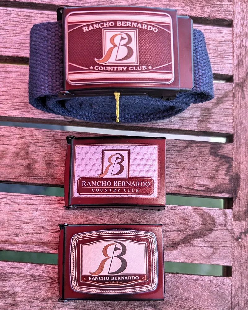 Three finished Rancho Bernardo Country Club belt buckles