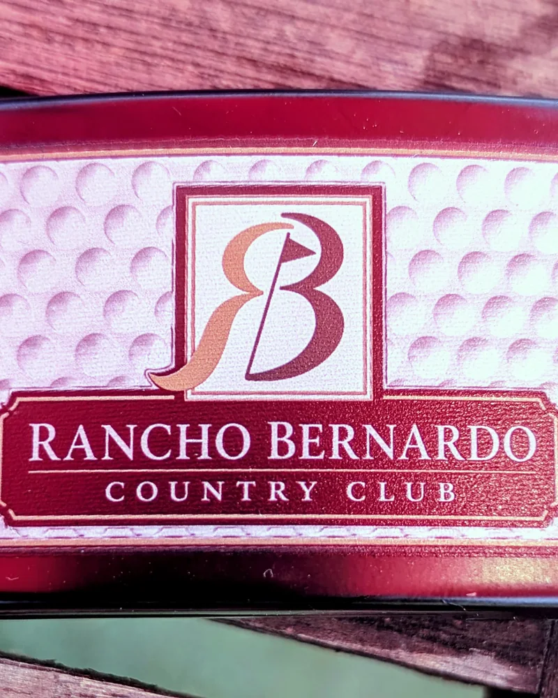 Close-up of the Rancho Bernardo Country Club buckle showing its golf-ball texture