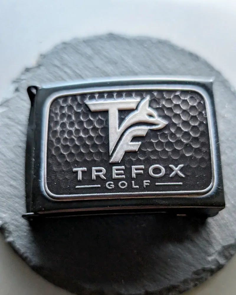 Finished TreFox Golf belt buckle on a slate round