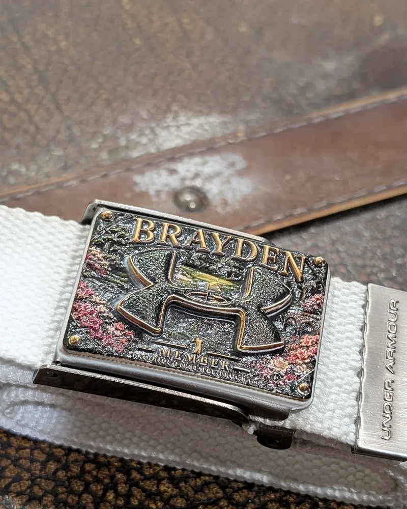 Name buckle reading BRAYDEN on a white strap